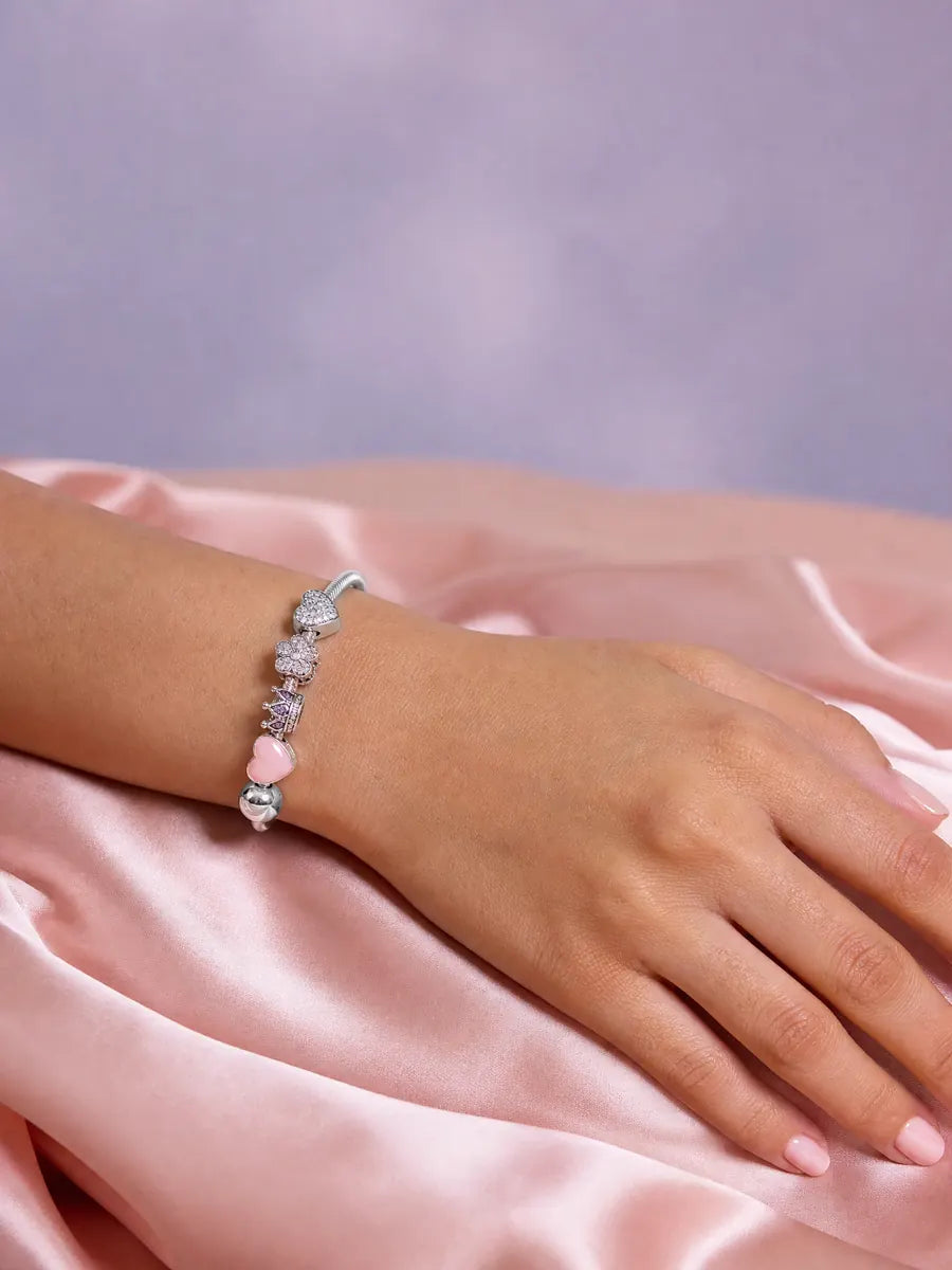 Sterling silver charm bracelet on a wrist