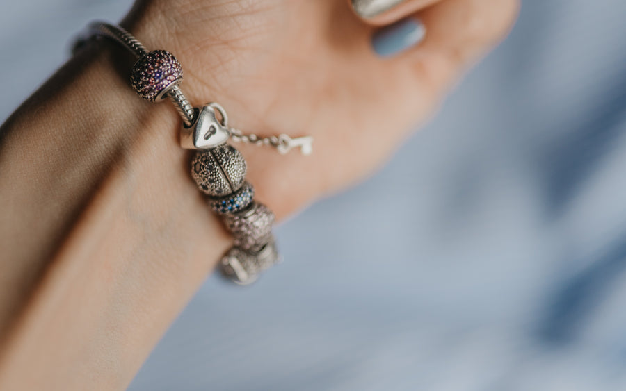 Sterling silver charm bracelet on a wrist