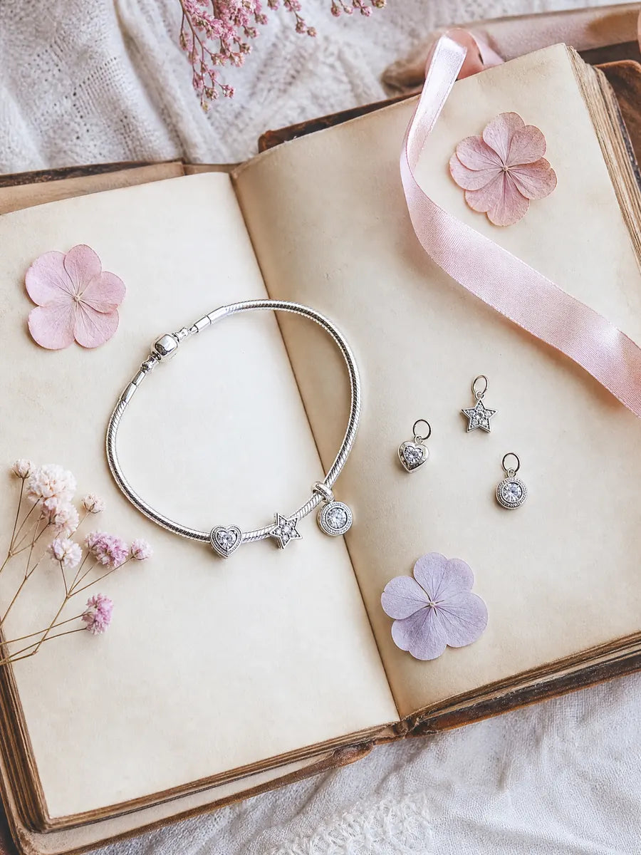 Sterling silver charms on an open vintage book